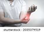 Muscle pain, arm pain, burning sensation, weak muscles, Office syndrome, Muscle tear caused by exercise, red inflamed zone. man having arm pain on a gray background. concept of health care