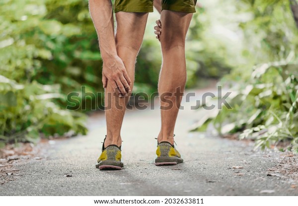 Muscle pain sports injury runner man touch leg\
calf in pain. Painful legs athlete massaging sore calf muscles\
during running training\
outdoor.