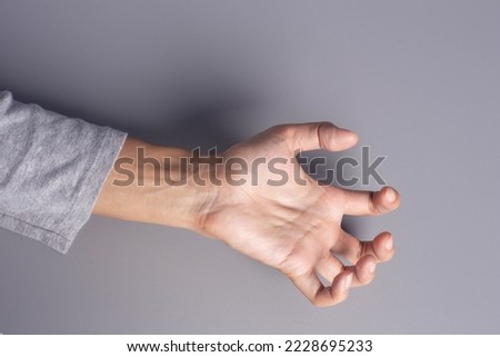 Muscle spasticity. muscle spasms from stroke, deformity of one hand abnormal finger flexion isolated on gray background Stock photo © 
