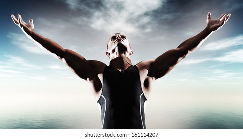 Muscled Fitness Triathlon Athlete. Arms Spread Wide. Victory. Standing Near Lake.