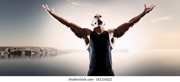 Muscled Fitness Triathlon Athlete. Arms Spread Wide. Victory. Standing Near Lake.