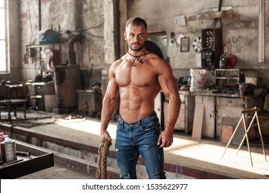 Muscled Half Naked Man At Work In An Old Factory.