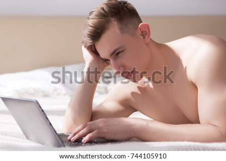 Muscled man have online chatting with girl on bed. Sunny romantic morning at home. Distance relationship communication.