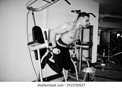 Muscular arab man training in modern gym. Fitness arabian men with naked torso doing exercises .