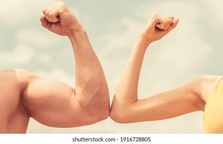 Muscular arm vs weak hand. Vs, fight hard. Competition, strength comparison. Rivalry concept. Hand, man arm fist Close-up. Rivalry, vs, challenge, strength comparison. Sporty man and woman.