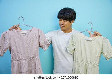 Muscular Asian Man Choosing A Dress