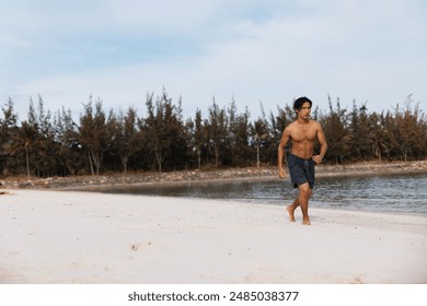 Muscular Asian Man Enjoying an Energetic Beach Workout at Sunset: Fitness, Strength, and Serenity - Powered by Shutterstock