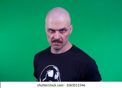 A Muscular Bald Man With A Mustache And A Black T-shirt. Portrait.