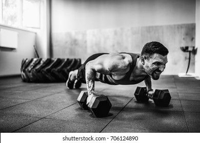 Muscular Bearded Man Doing Pushup Exercise With Dumbbell 