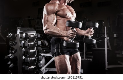 Muscular Body Building Men Training At The Gym