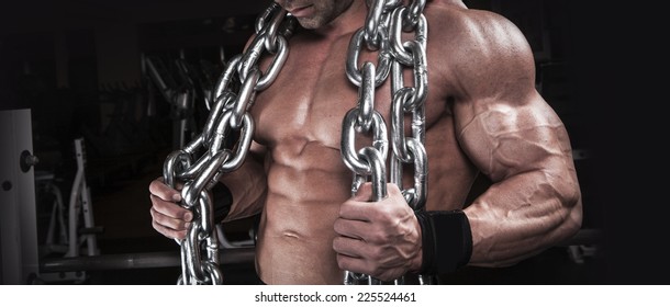 Muscular Body Building Men Training With Chain At The Gym 