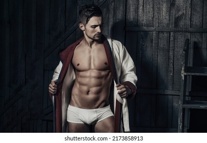 Muscular Body. Strong Muscular Man With Perfect Athletic Body Over Black Background. Abs, Six Pack.