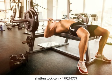 Muscular bodybuilder bench press workout