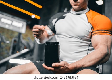 muscular bodybuilding athlete with perfect body holding protein or whey jar mockup in gym, athletic man in fitness club preparing sport nutrition and supplement - Powered by Shutterstock