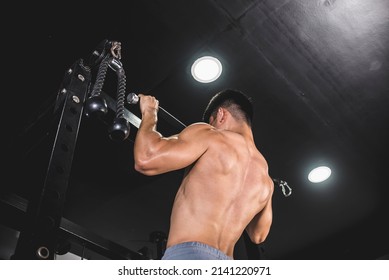 A Muscular And Buff Asian Guy Trains His Back At The Gym. Doing A Set Of Pull-ups. Shirtless Revealing His Ripped Physique.