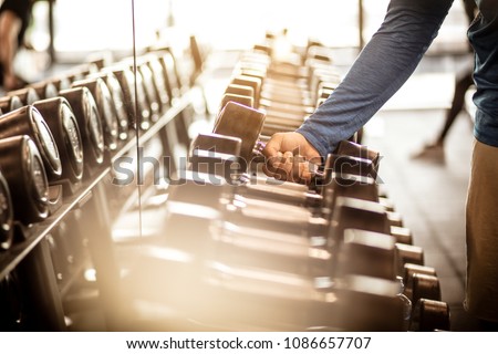 Image, Stock Photo man taking a weight plate in a gym