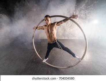 Muscular Circus Performer Spin In The Big Wheel 