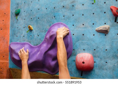 Muscular Climber Hand On The Bouldering Climbing Wall Grip Close-up