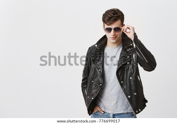 Muscular Confident Male Posing Indoors Against Stock Photo Edit