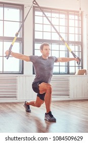 Muscular Fitness Male Doing Exercise With TRX. Functional Workout At Home With TRX Loops.