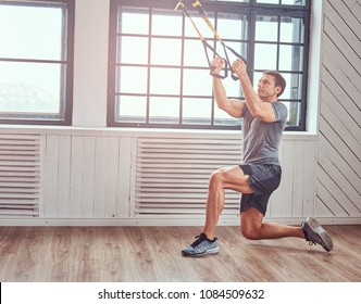 Muscular Fitness Male Doing Exercise With TRX. Functional Workout At Home With TRX Loops.