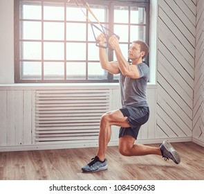 Muscular Fitness Male Doing Exercise With TRX. Functional Workout At Home With TRX Loops.