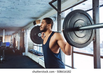 Muscular Fitness Man Doing Heavy Exercise in the gym using barbell - Shutterstock ID 508616182