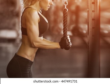 Muscular fitness woman doing exercises.Concept of healthy lifestyle. Cross fit bodybuilder  in the gym.