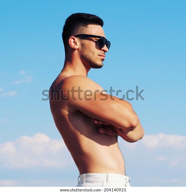 Muscular Guy Posing On Beach Photo Stock Image Download Now