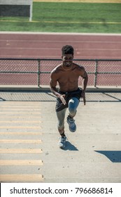 Muscular Jamaican Athlete Smiling As He Power Sprints Up The Stairs.