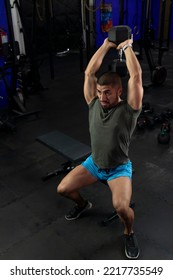 Muscular Latino Man Doing Exercises For Biceps Sitting On A Gym Bench