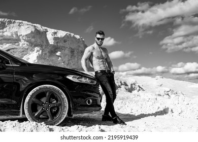 Muscular Macho Man Standing With A Car Outdoor. Male Model With Naked Torso.