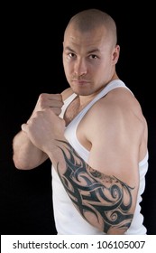 Muscular Man Body With A Tattoo On His Arm Looking At The Camera