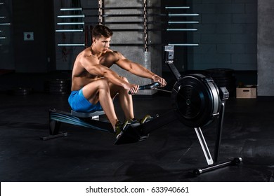 Muscular man doing exercise for legs in the gym