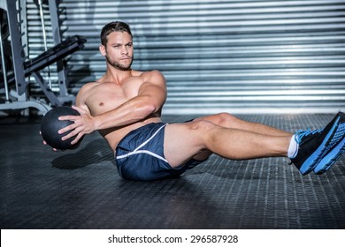 Muscular Man Doing Exercise With Medicine Ball In Crossfit Gym