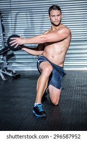 Muscular Man Doing Exercise With Medicine Ball In Crossfit Gym