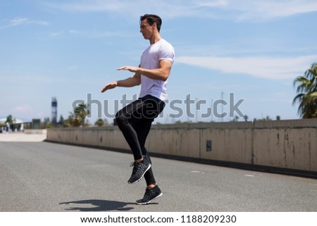 Similar – Happy man and jumping outdoors, warmup before jogging