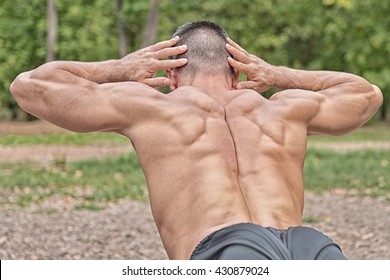 Muscular Man Doing Lower Back Exercise