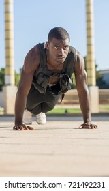 Muscular Man Doing Push-ups With A Full Of Weight Vest