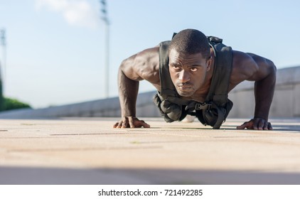 Muscular Man Doing Push-ups With A Full Of Weight Vest