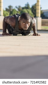 Muscular Man Doing Push-ups With A Full Of Weight Vest