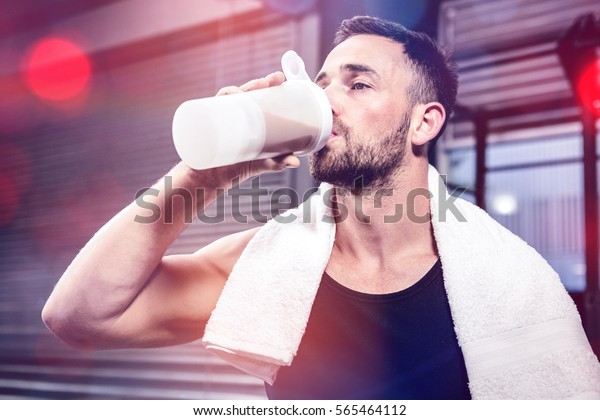Muscular man\
drinking protein shake at crossfit\
gym