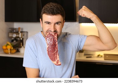 Muscular man eating beef and flexing biceps  - Shutterstock ID 2238394673