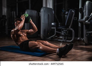 Muscular Man Exercise With Medicine Ball.