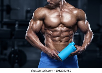 Muscular Man In Gym With Shaker. Strong Male Abs, Working Out