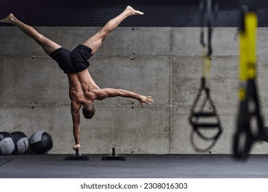A muscular man in a handstand position, showcasing his exceptional balance and body control while performing a variety of exercises to enhance his overall body stability and strength in a modern gym