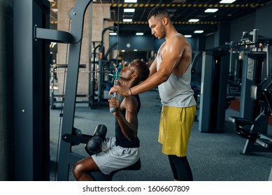 Muscular Man And His Instructor, Training In Gym