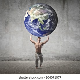 Muscular man holding the Earth in his hands [Elements of this image furnished by NASA]