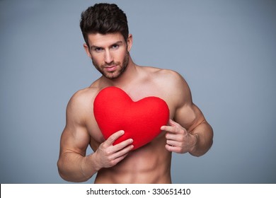 Muscular Man Holding Heart Shape
