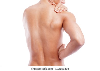 Muscular man holding his back and shoulder in pain, isolated on white background